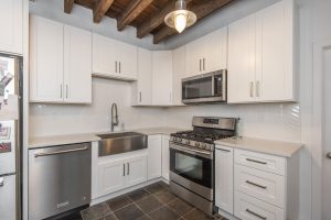 Kitchen with white backsplash