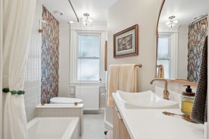 Bathroom with both tile and wallpaper.