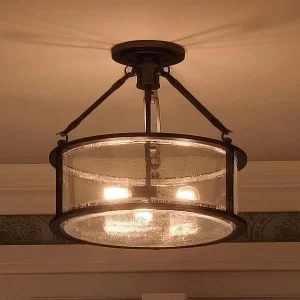 A semi flush light made of black hardware and glass