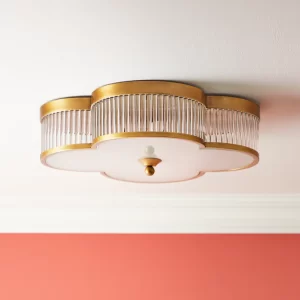 A clover shaped ceiling light flush with the wall, that was gold, clear, and white glass. 
